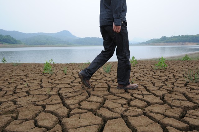 A man walks along the dried-up the banks